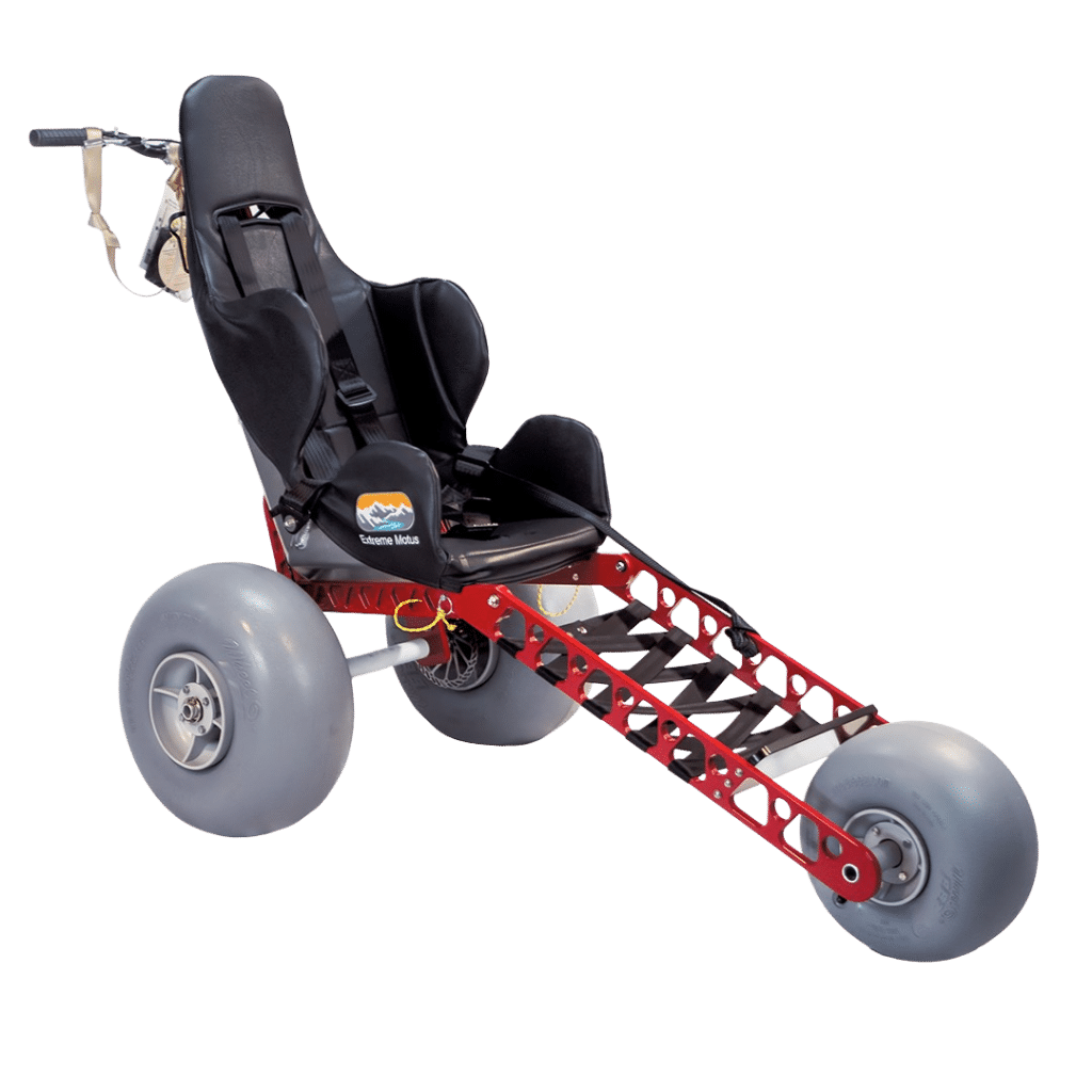 A three-wheeled, all-terrain wheelchair with large gray tires, a black seat, and a red metal frame for outdoor mobility.
